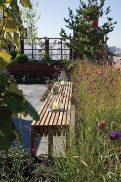 A bench sits opposite the grilling station near the seating alcove.