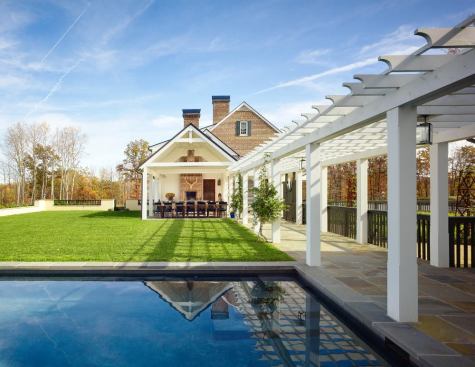 An outdoor dining porch overlooks the pool.