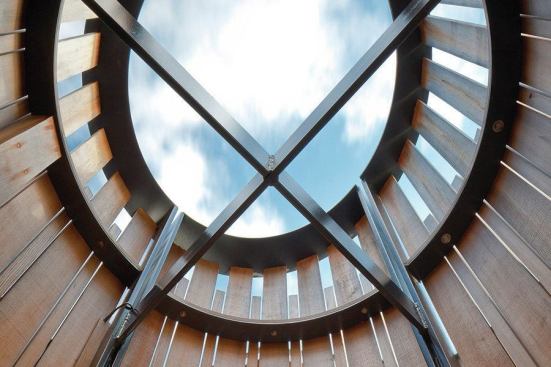 Once the steel frame had been lowered onto the porch, the team rotated it until the structural crossbars were in perfect alignment with the orthogonal points of a compass.