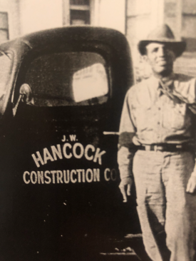 J.W. Hancock, who co-founded one of Arizona's oldest family-owned home-building firms with his wife Maggi, stands in front of his truck.