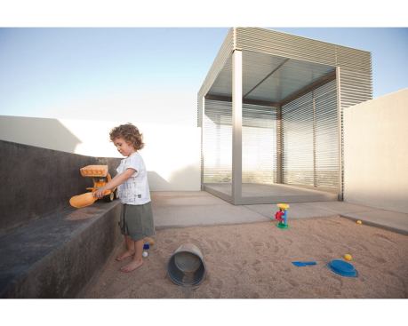 A concrete bench provides a work counter for children and a back-saving seat for adults.