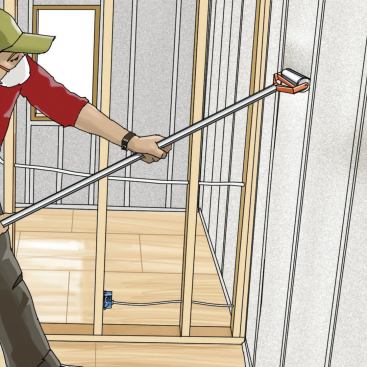 3. Flatten the Surface

Take the time to compact the filled cavities with an aluminum roller. If this step is omitted, any bulging of the netted insulation between studs will put pressure on the drywall, eventually causing the screws to pull through its paper facing. A quick pass of the hand is enough to confirm that the insulation lies flush with the framing.