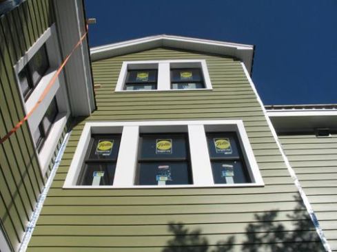 The house with its new siding, windows, and trim installed.