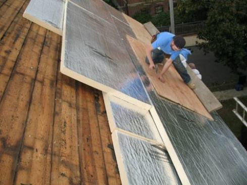 Once the two layers of foam were installed, plywood sheathing was laid on top.