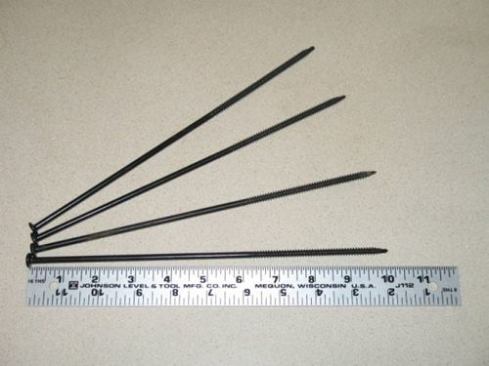 The 10-inch screws used to secure the new roof deck, 6 inches of foam, and old roof deck into the rafters.