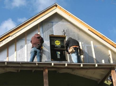 Furring strips were attached to the foam board to create an air space behind the siding. The space promotes drainage, allowing the house to dry out.