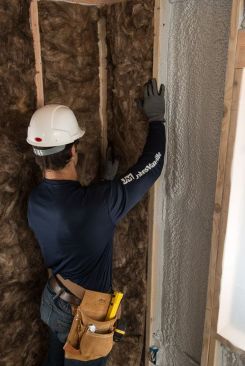 Installing fiberglass batts or rolls over spray-foam insulation combines the robust air-sealing benefits of foam with the cost-effective thermal and sound-control performance of fiberglass.