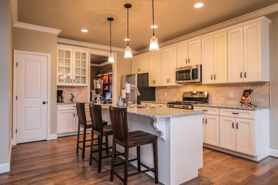Kitchens
are more important than ever. Here, the plan’s smaller corner bar has been
transformed into this spacious island.Photo courtesy of Frank Batson Homes.
