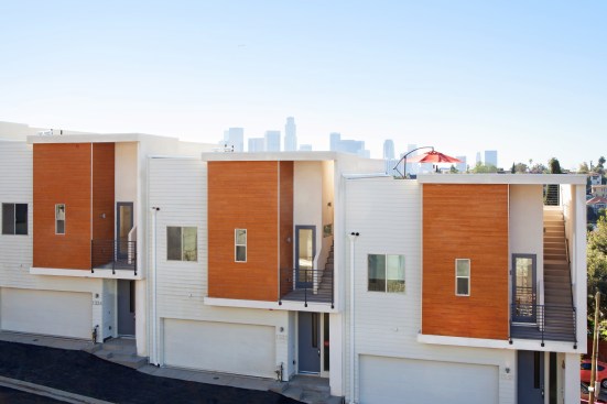 Rear-loaded street-grade garages sit about 10 feet higher than the front door on the opposite side.