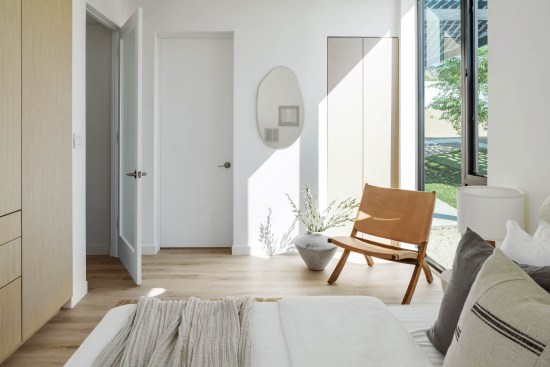 The primary suite features a space-efficient closet and cabinets with an attached bath.