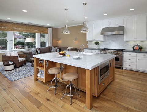 Interiors are as contemporary as the exteriors are historic. The open kitchen and generous island welcome casual gatherings. Finished basements include a bar, bath, and media room.