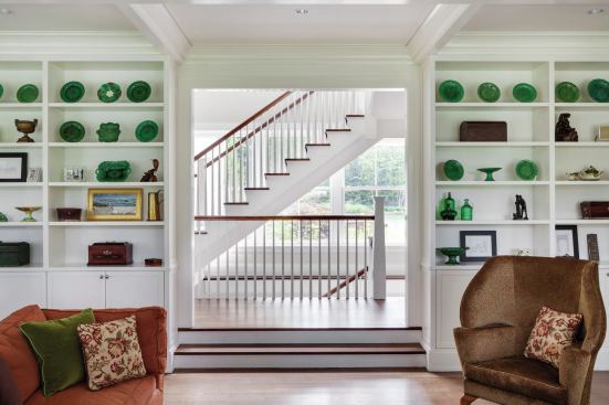 The main stair hall is lit by a wall of windows.