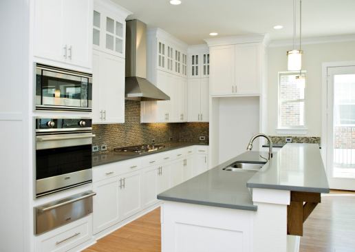 The semi-gloss paint used on kitchen cabinets finishes like oil, but it’s water-based and low-VOC. One of the few splurges in this sensible house is the kitchen’s glass tile backsplash.