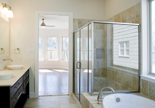 The master bedroom, seen through the master bath, is on the first floor with a bay that gets southern exposure and faces the backyard. All windows are low-E2 and vinyl-clad with argon gas.