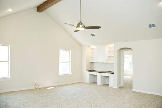 Adjacent to the second bedroom is a family room with a high vaulted ceiling and carpet made with recycled fibers.