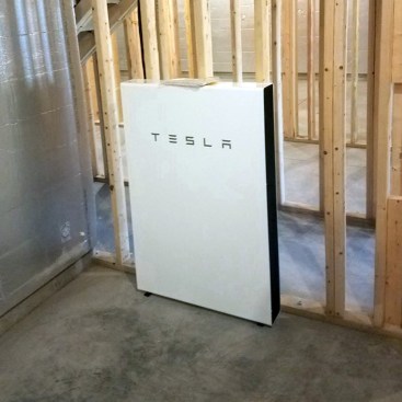 The Tesla Powerwall is a rechargeable lithium ion battery that works in conjunction with solar panels to store excess energy.