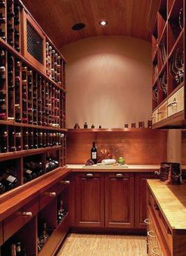 Designer Sherry Hanan recommended mahogany as the dominant wood for its durability in humidity and its upscale appearance. The counter top on the right is made from the clients’ maple kitchen table. LED lighting is hidden under the cabinets. The copper shelving (on rear wall), backsplash and metal drawer liners were custom made by Corley Roofing & Sheet Metal. The floating cork floor is from WE Cork Avant Garde collection. 