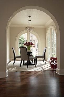 The new breakfast room's large windows echo the arched doorways and windows of the living room.