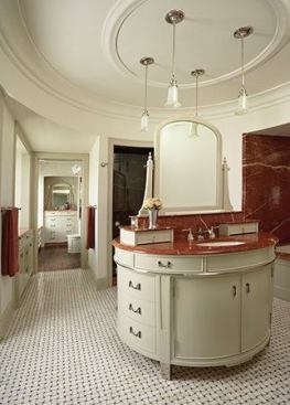 Two first-floor bedrooms and baths were combined to form a large, luxurious master suite. Rojo Alicante marble distinguishes the shower, bath, and vanity top.