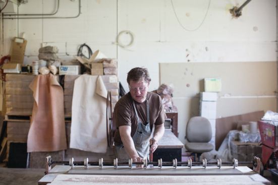 Pete Jochimsen, production manager at North Prairie Tileworks, cuts clay into 4x4 squares after it has been pressed. The Minneapolis company produces its own glaze colors for the hand-painted tiles. Orders range from one tile to several thousand square feet and are installed in speculative, custom, and restoration projects.