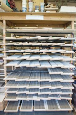 Tiles pressed and cut into 4x4 inch squares sit to dry. 