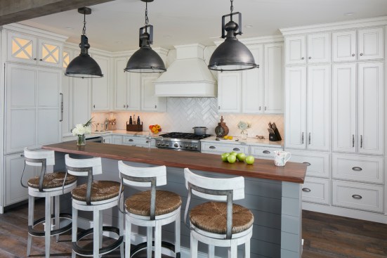 Butcher block island bar seating was added for quick breakfasts before the beach and to add contrast in the white kitchen.