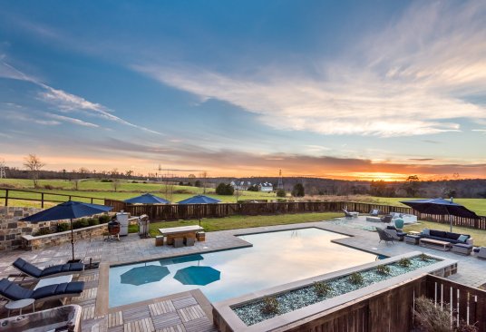 The architects added a generous outdoor living area to the back of the project, including a nontraditional-shaped pool and standard hot tub.