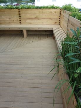 Raised planters create privacy and form backs for integrated benches.