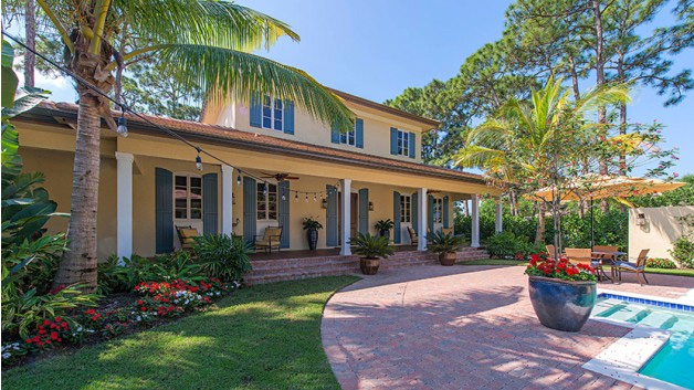 A large courtyard in front and a lanai in back provide serious indoor-outdoor living. The master suite invites owners to relax in the enormous shower (boasting double showerheads), with two sinks and walk-in closets nearby. Every bedroom features a private bathroom. A loft upstairs can be used as a homework space or playroom. See more images and the floor plan.