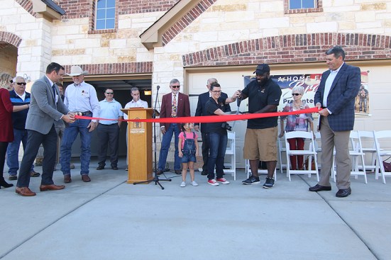 Nick and Shelby Nelms, center, were given their new home in December 2016.