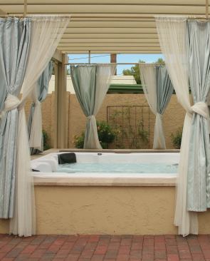 Keeping It Eclectic: This Phoenix, Ariz. spa features a stucco ramada to match the historic home.