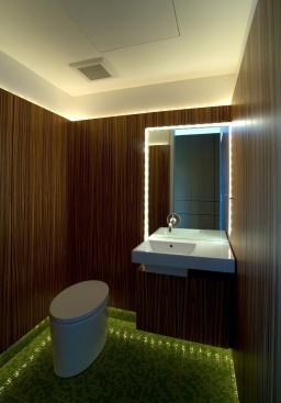 While low lighting maintains the hip mood of this posh penthouse in downtown Boulder, Colo., the design stays functional with a lighted mirror that provides plenty of white light to illuminate a user’s face. Architect: Arch11, Boulder, Colo. Builder: Wyatt Construction, Boulder