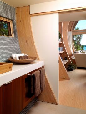 The curved architecture and exposed beams extend throughout the home, creating a unified aesthetic.