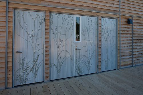 The Iowa State students covered these energy-efficient Pella doors with a material made of resin and recycled grain and etched a wheat pattern into them.