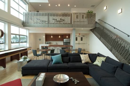 Punched-out metal panels add a unique touch to the stair and loft elements of this transit-oriented community in Berkeley, Calif. Designed by Christiani Johnson Architects, the project is anchored by a rehabbed Spanish colonial train station, a style theme lightly echoed by the repeating leaf motif in the stair panels.