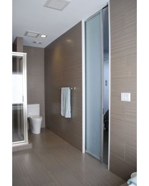 Space and natural light are two of the most precious resources in any home, and this configuration saves on both. As the adjoining bedroom to this master bath was blessed with an abundance of natural light, Studio RED Architects made the most of it with a frosted sliding pocket door that lends privacy while allowing light to filter though. The natural light accentuates the bath’s neutral tones, creating a spa-like space.