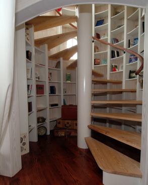 As part of the home’s maritime theme, this custom curved library stair evokes a lighthouse’s climb and leads to a retreat with 360 degree views of a nearby lake and mountains.
