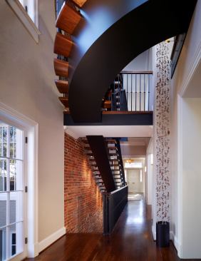 Adding a new twist to a historic row house in Washington, D.C.’s Georgetown neighborhood, this beautiful floating stair consists of a center steel stringer fitted with custom walnut treads. Designed by Barnes Vanze Architects, the staircase is as practical as it is beautiful, with a gentle rise-to-run ratio that is easy on elderly climbers. Plaster was stripped from the adjacent wall to reveal raw brick, which when combined with the slick stair elements dramatizes the contrast between old and new.