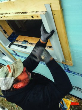Roofers installed metal window trim.