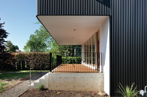 Porches are carved out of the larger volume, as if carved from an apple, and clad in exterior grade plywood, painted white.