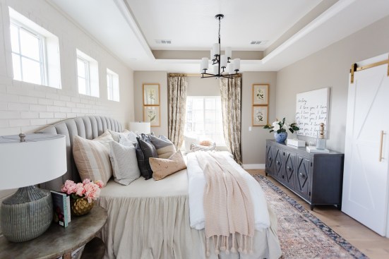 Double doors welcome owners into their master suite with a tray ceiling and copious windows for ample natural light.