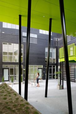 The columns supporting a second-story footbridge resemble the bamboo that flourishes in the courtyard.