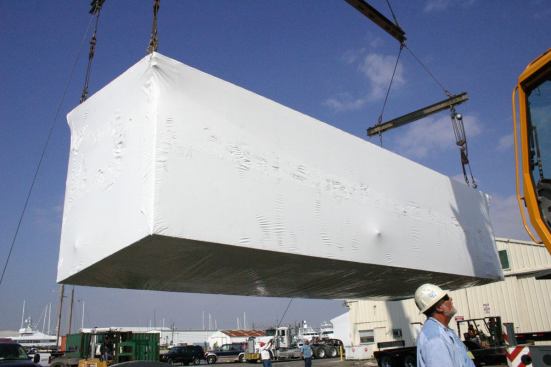 Concrete sections being loaded for transport.