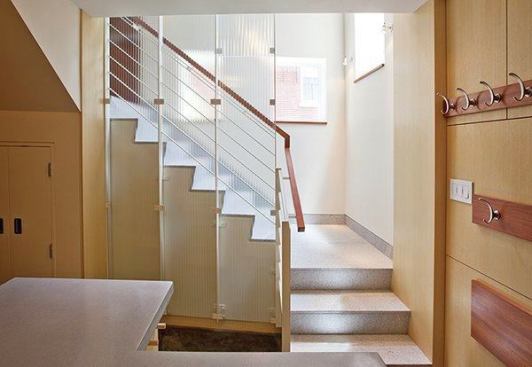 For the stair landing into the new basement, the clients saw an opportunity to create a railing that is a commissioned work of art. The stair granite matches the thresholds typical of the neighborhood’s historical entrances. The stair rail is by Wovensteel; the glass screen is from Bendheim, installed by Prestige Glass.