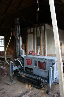 HP Building Solutions maneuvered compact drilling equipment into the partially demolished existing structure to help contain some of the mud generated by the geothermal installation.