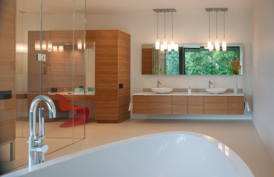 Simple but stylish light fixtures illuminate this modern bathroom. Project: Riggins House by Robert Gurney Architect