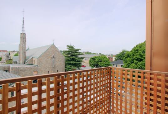 Fine details such as lattice balconies tie in with the historic church campus.