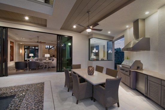 A covered outdoor kitchen sits just outside the great room and kitchen/dining area.