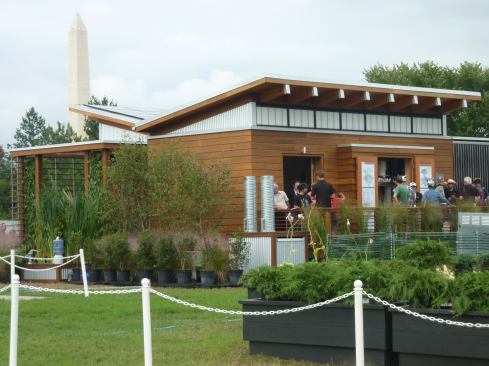 WaterShed's rear elevation showing the butterfly roof, mechanical closet, and solar collection tubes on back of courtyard wall.