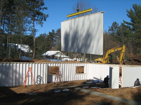 The panels are craned into place on site.